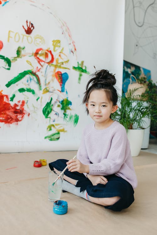 A Girl Holding a Paint Brush