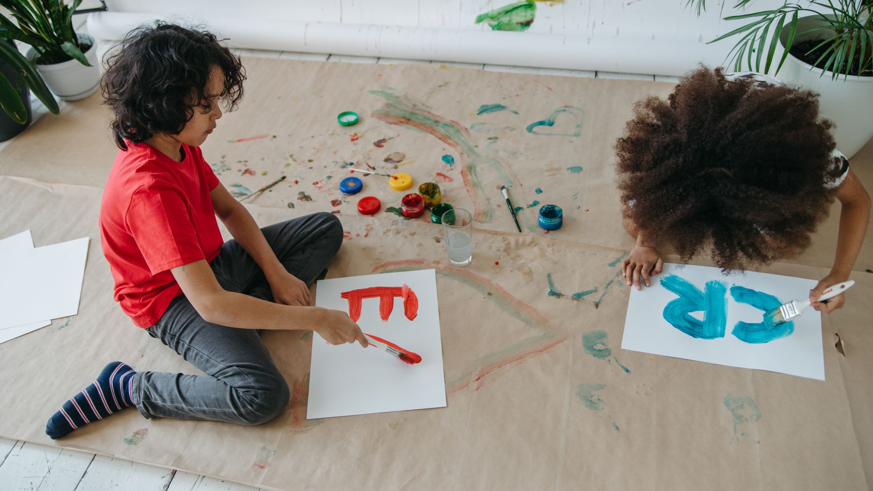Two children painting together, showing how a creative hobby can become something they share or sell