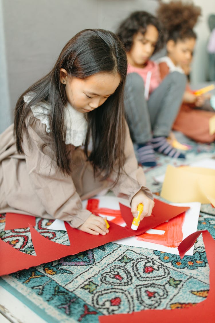 A Girl In Brown Dress Making An Artwork