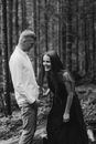 Man in White Dress Shirt and Woman in Black Dress