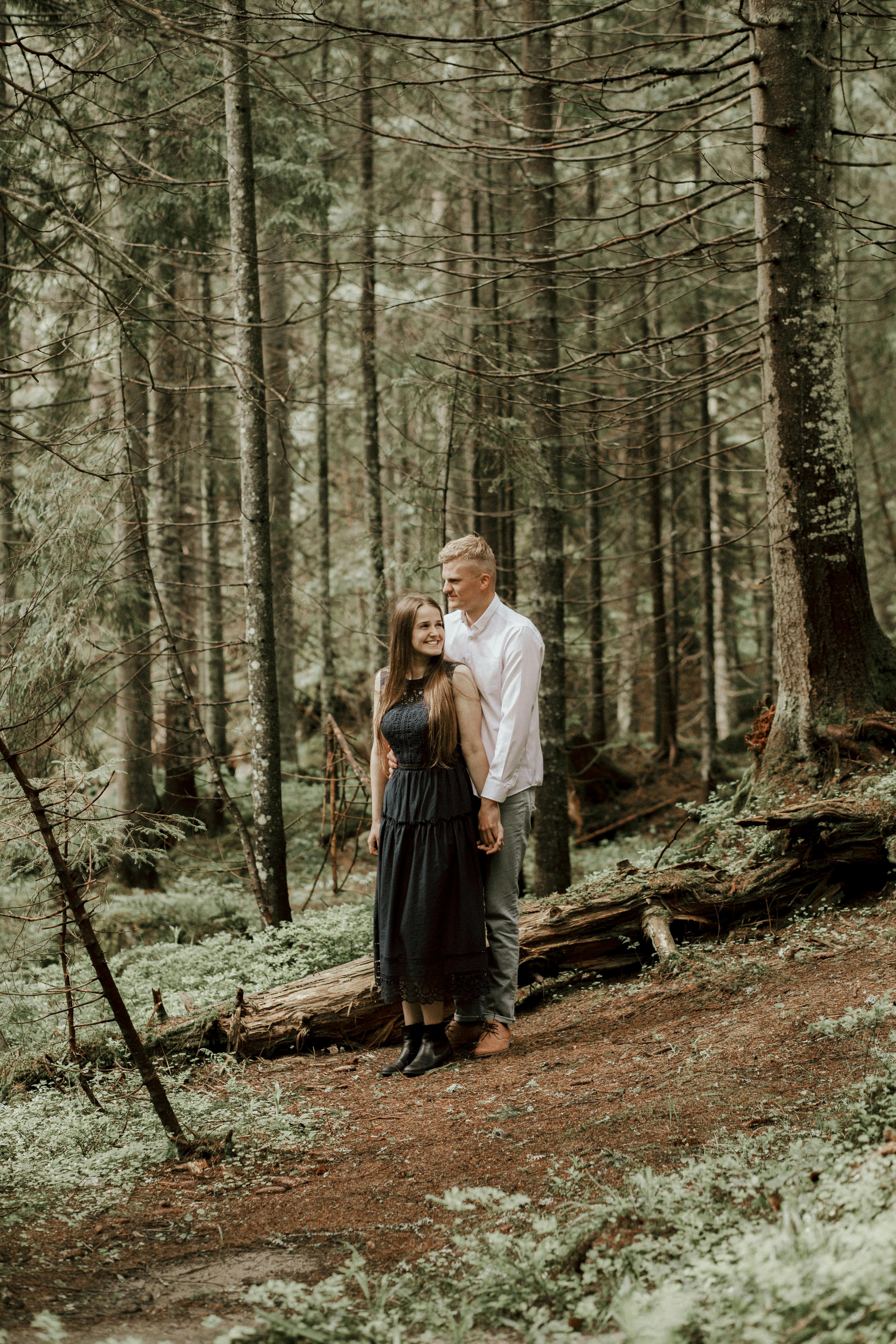 Man and Woman Standing Near the Green Trees · Free Stock Photo