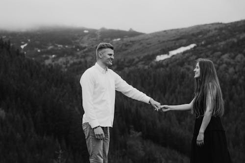 Free Man Holding the Hand of a Woman Stock Photo