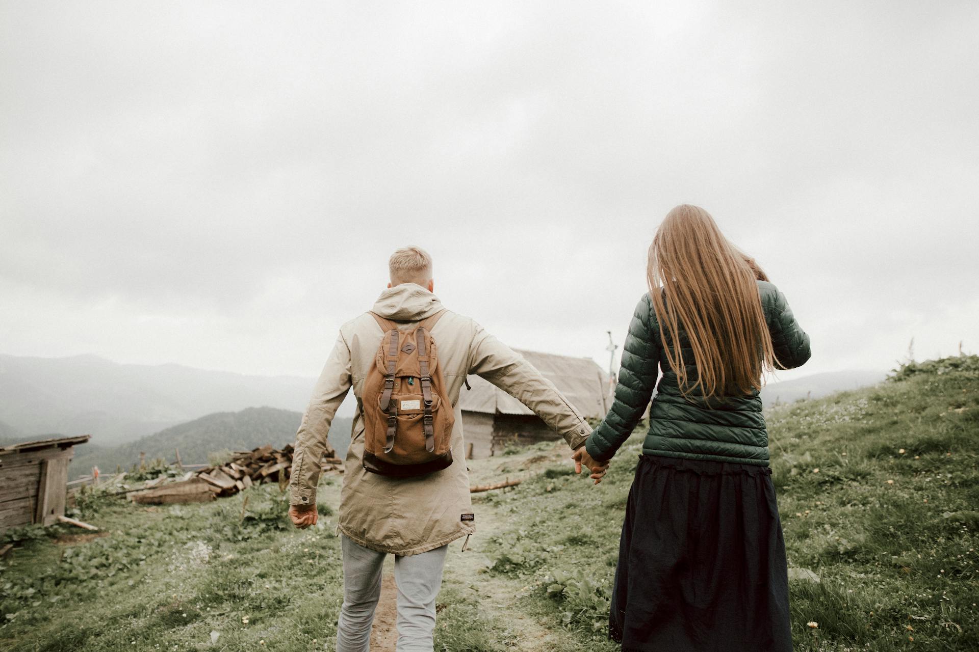 Man and Woman Walking Towards A Wooden Shed