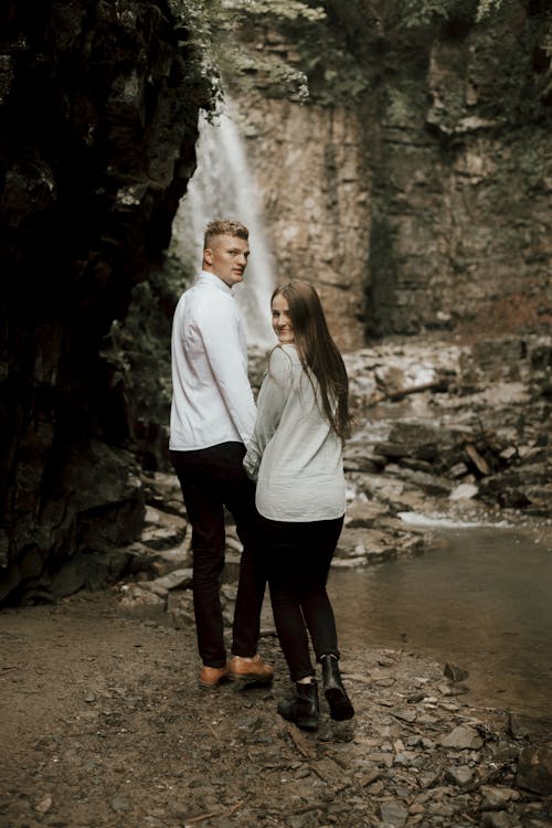 Couple Standing by the Waterfall 