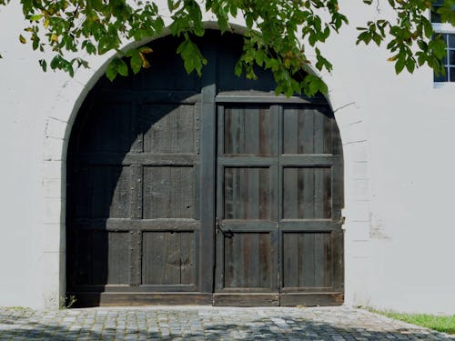 Brown Wooden Door on White Concrete Wall