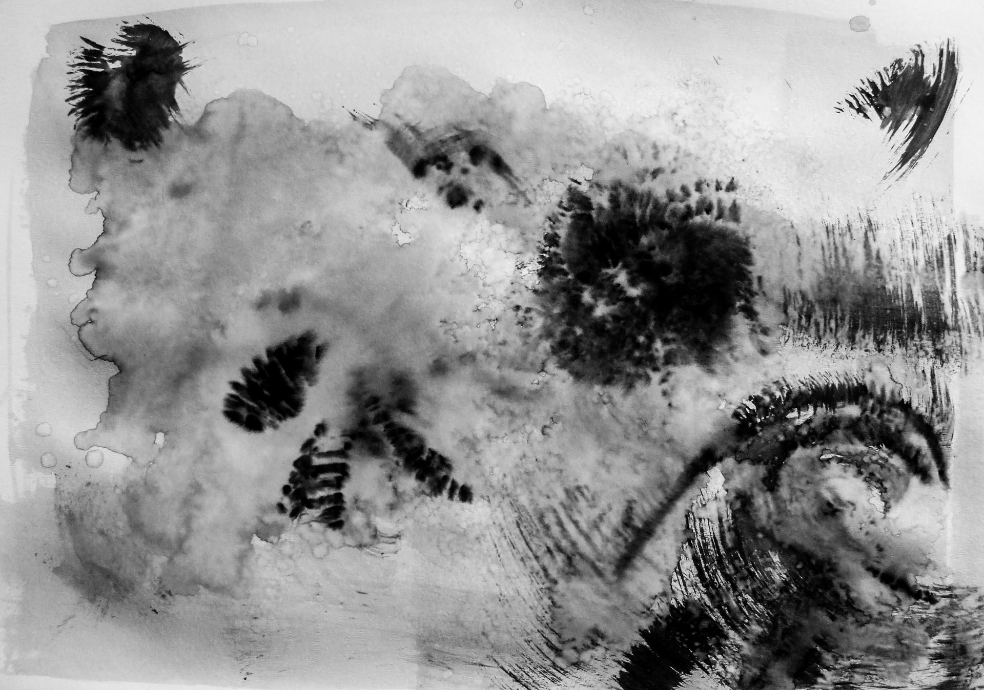 Monochromatic abstract art with black watercolor splotches and strokes on paper.