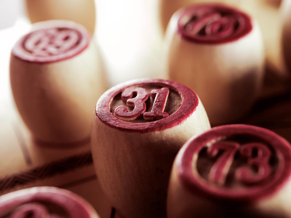 Numbered wooden bingo pieces ready for a hosted game