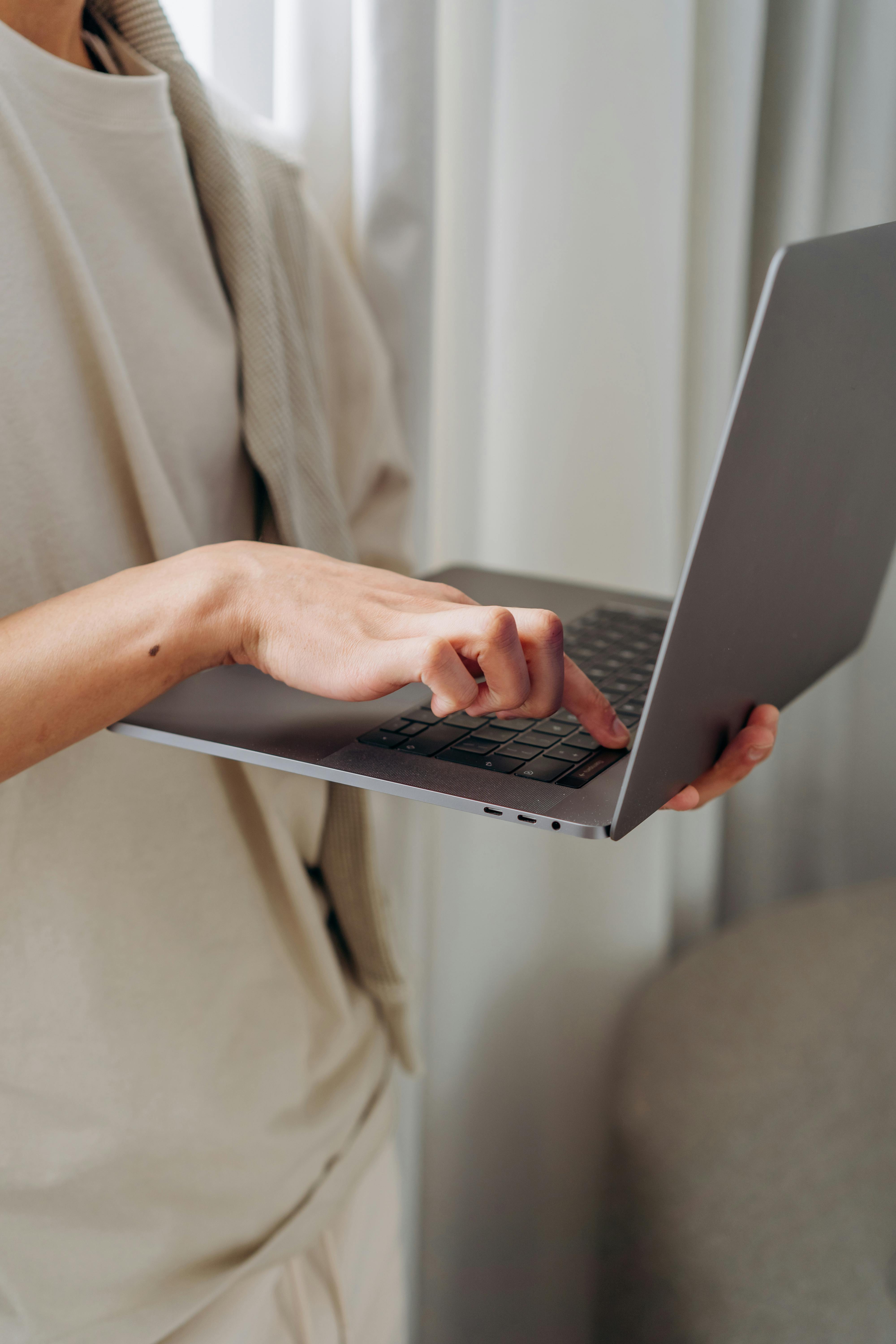 person typing on laptop