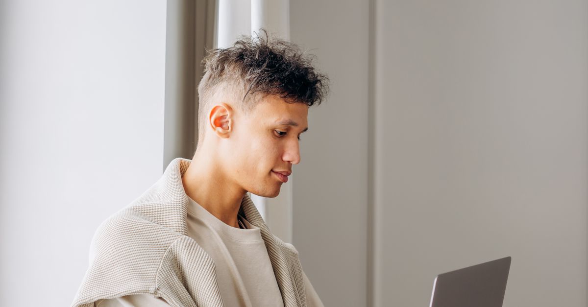 Man Using Windows Man Using Laptop Near Window Sill · Free Stock Photo