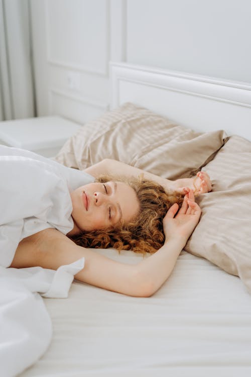 Woman lying down in bed stock photo (147094) - YouWorkForThem