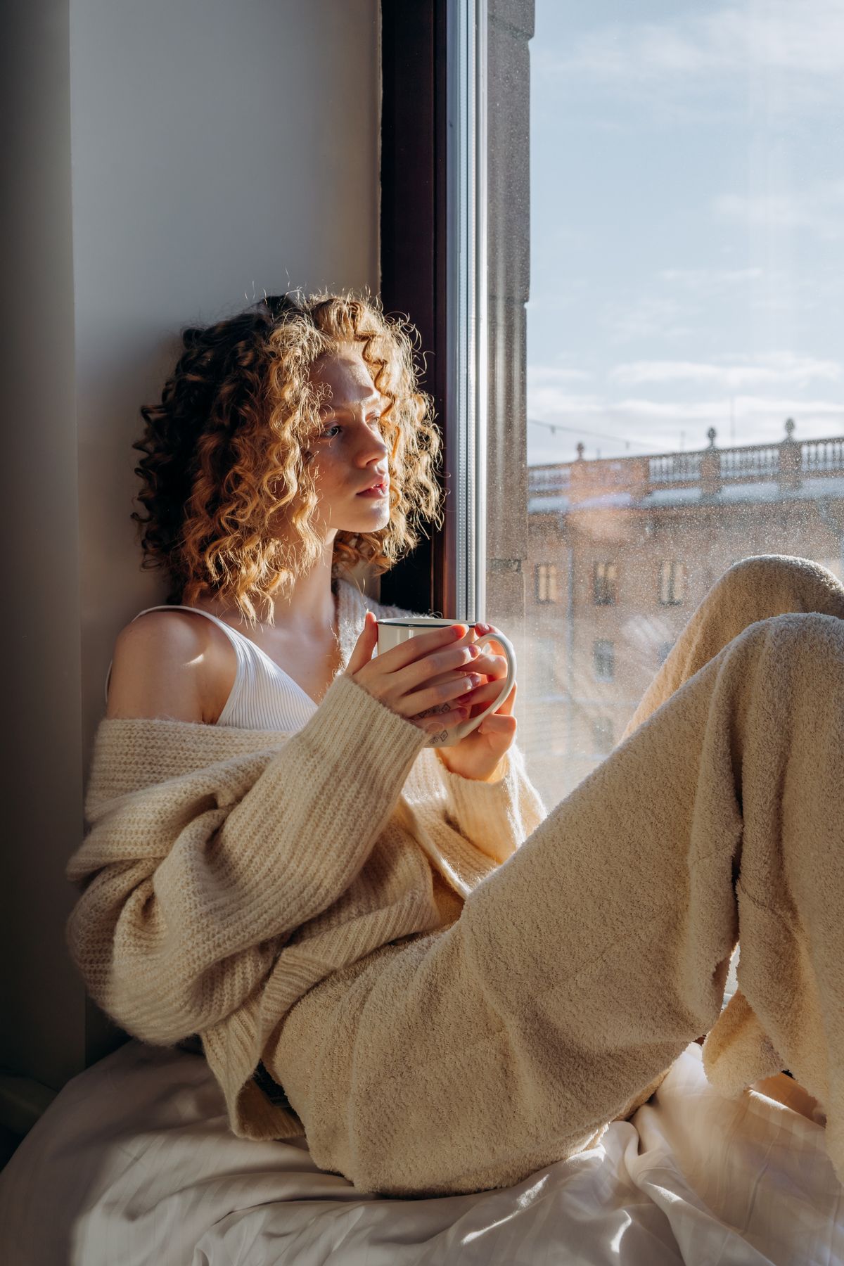 Person sitting calmly by a window in morning natural light