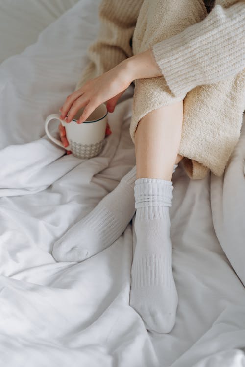 Free Woman in White Sweater Holding White Ceramic Mug Stock Photo