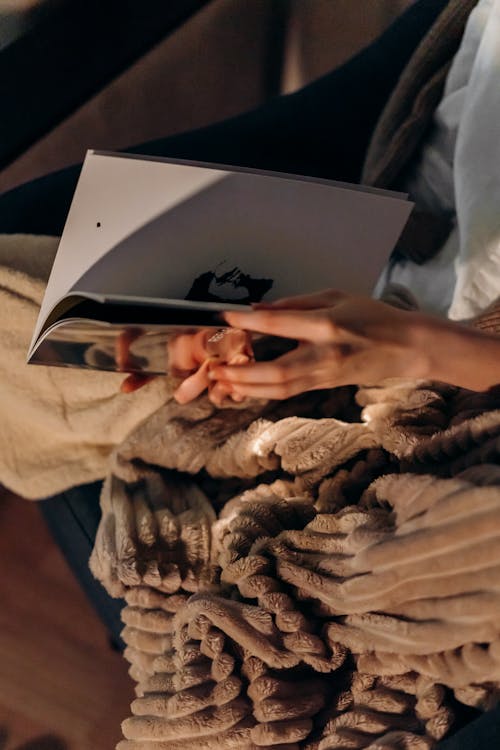 A Person Flipping Pages of a Book