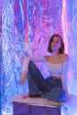 Woman in White Off Shoulder Long Sleeve Shirt and Blue Denim Jeans Sitting on Brown and