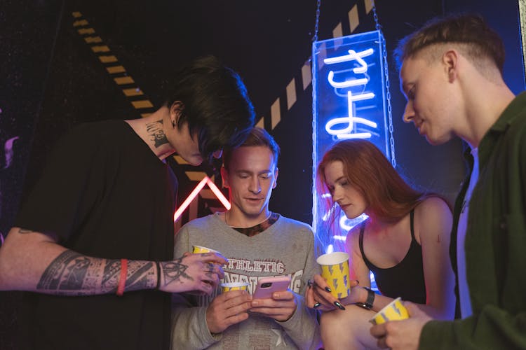 Group Of People Holding Yellow And Silver Cup