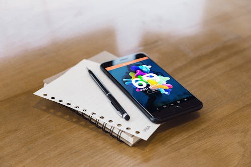 Black Pen Beside Black Smartphone