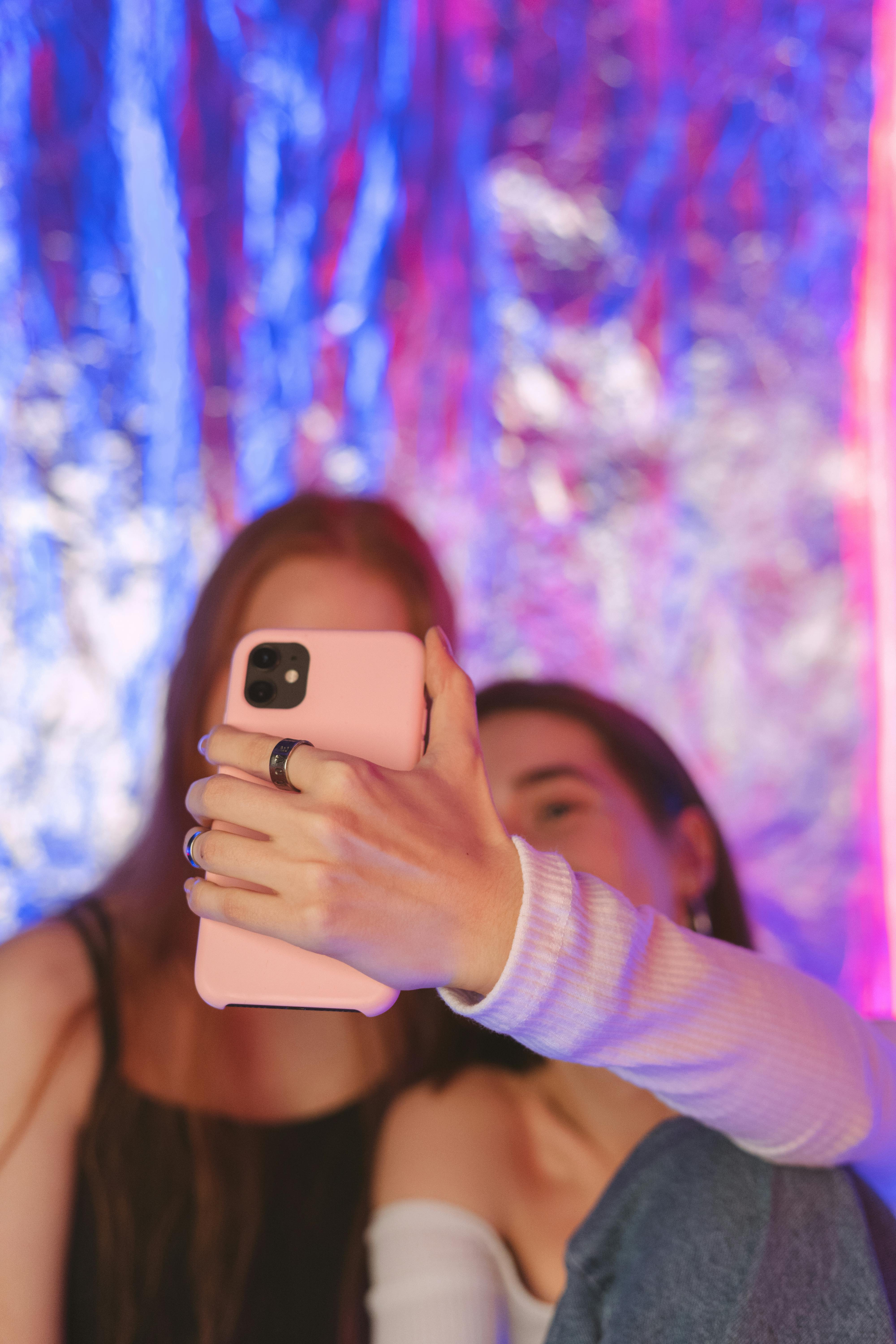 A guy and a girl take a selfie at night, stand in profile in different poses