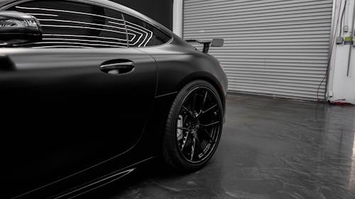 Free Black Matte Car Parked in Front of Garage Door Stock Photo