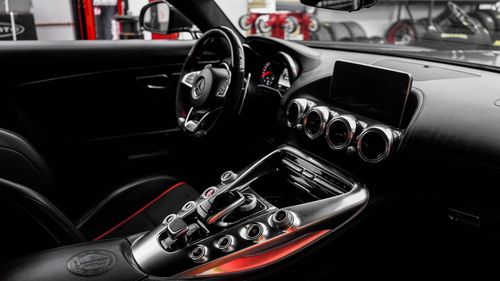 Free Modern luxury car interior showcasing a high-tech dashboard and sleek design features. Stock Photo