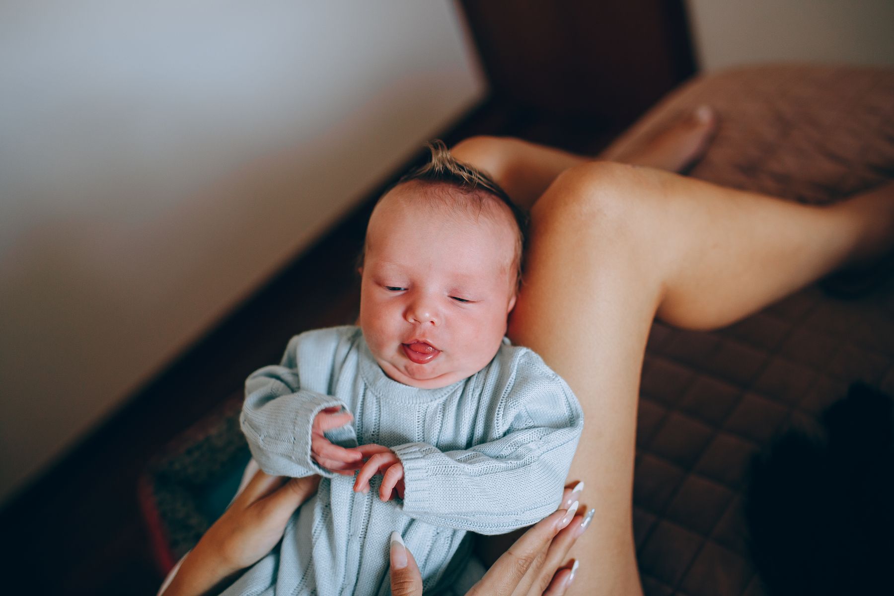 Mother resting with her newborn baby in a calm bedroom