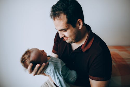 Free Content father with baby on hands Stock Photo