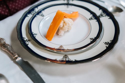 Orange and White Food on White and Black Ceramic Plate