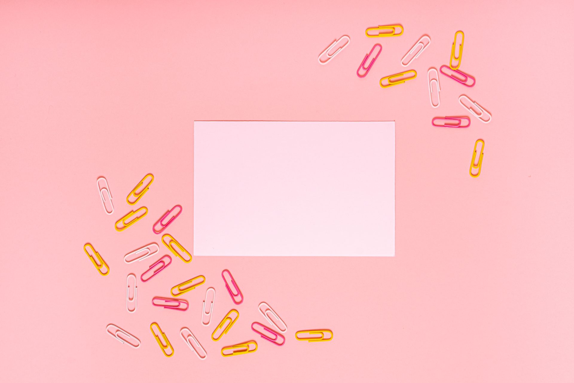Paper Clips and White Paper on Pink Background