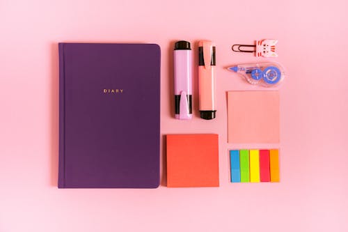 Free Purple Diary on Pink Background Stock Photo
