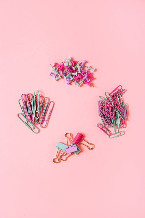 Free Paper Clips and Pins on Pink Background Stock Photo