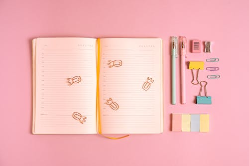 Office Supplies on Pink Background