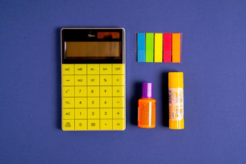 Free Yellow and Black Calculator on Blue Background Stock Photo