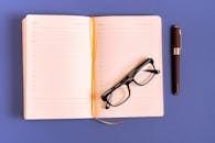 White Notebook on Blue Background