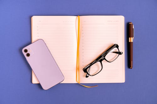 Black Framed Eyeglasses on White Book Page