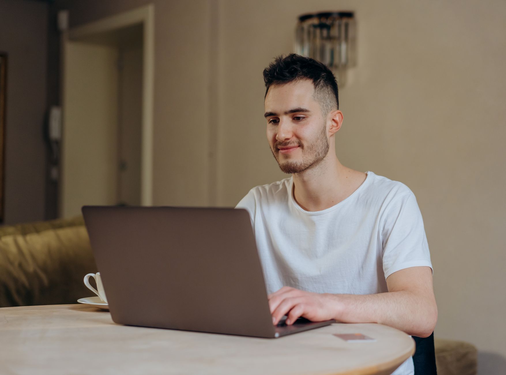 A smiling person chatting naturally via their computer