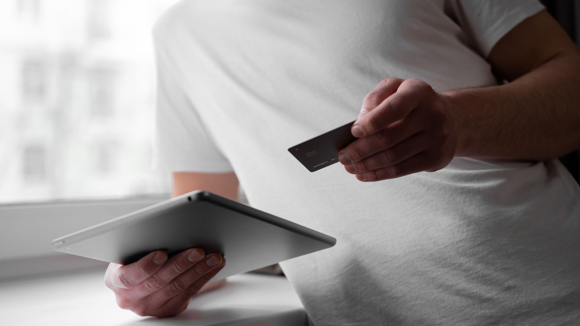 Modafinil Paypal Payment Option: A Comprehensive Guide Man in a white shirt using a tablet and credit card indoors for online transaction — modafinil paypal payment option