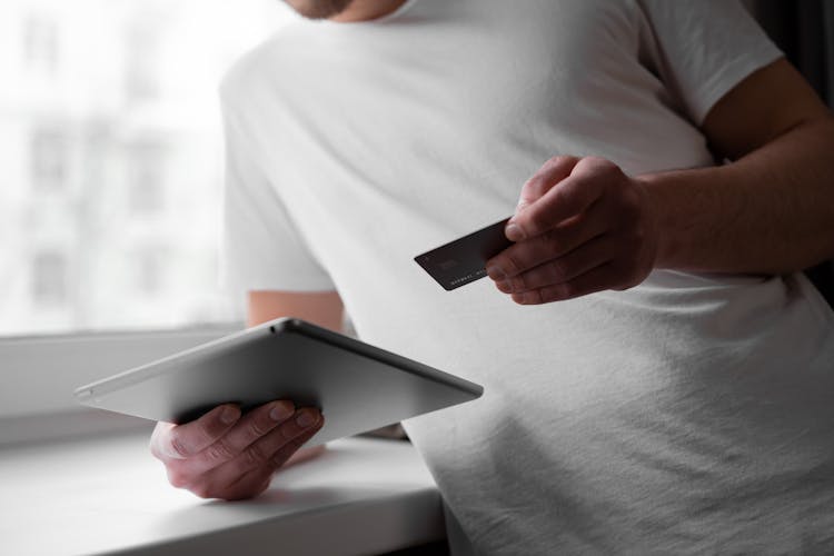 A Man Using A Tablet In Making Business Transaction