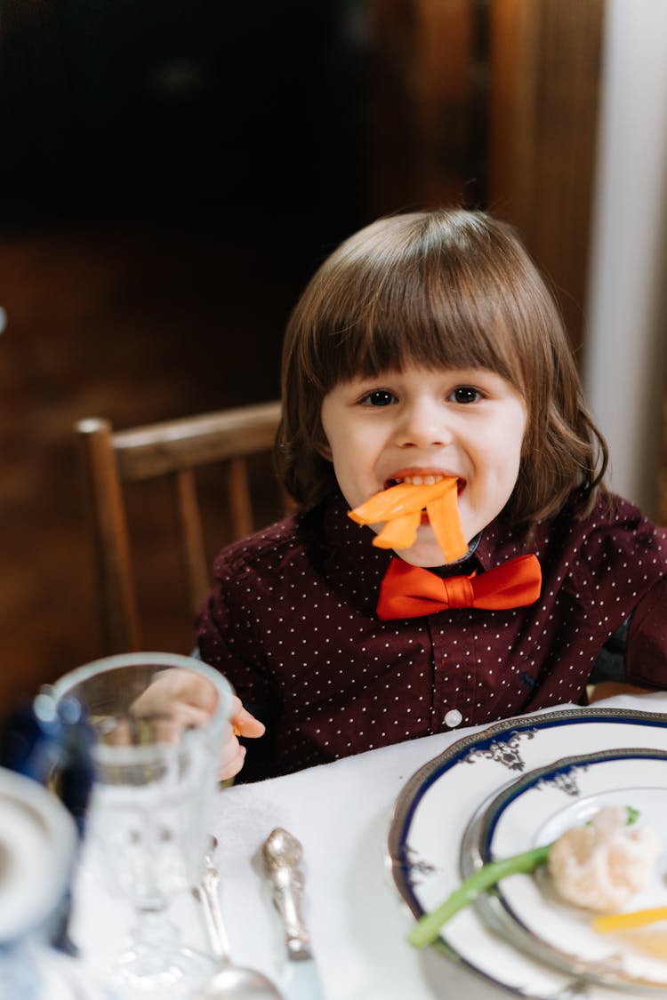 A Boy Eating Healthy Food At Dinner