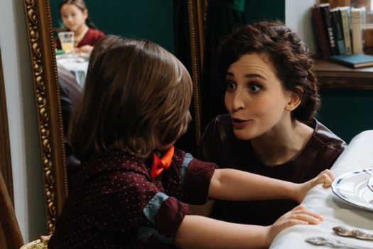 Woman in Black and Red Shirt with a Child