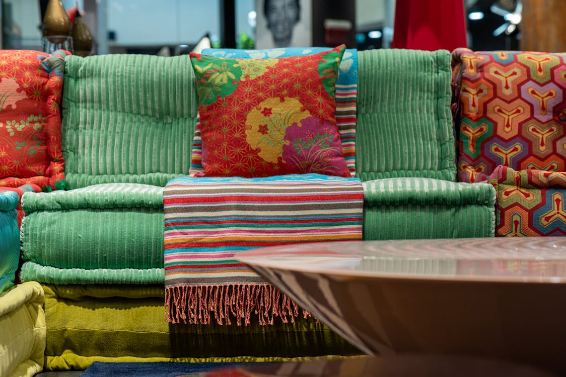 Colorful sofa near round table in flat