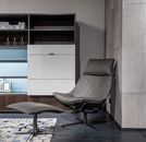 Chair with footrest near cupboard in stylish apartment