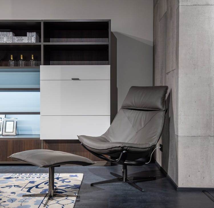 Chair With Footrest Near Cupboard In Stylish Apartment