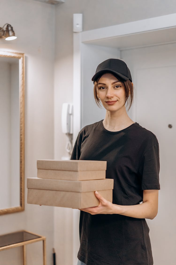 A Woman In Black Crew Neck T-shirt Making A Delivery