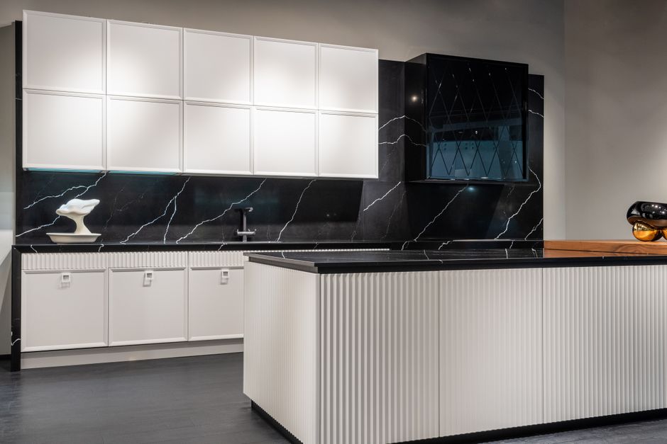 Contemporary kitchen interior design with empty white and black furniture in modern stylish apartment