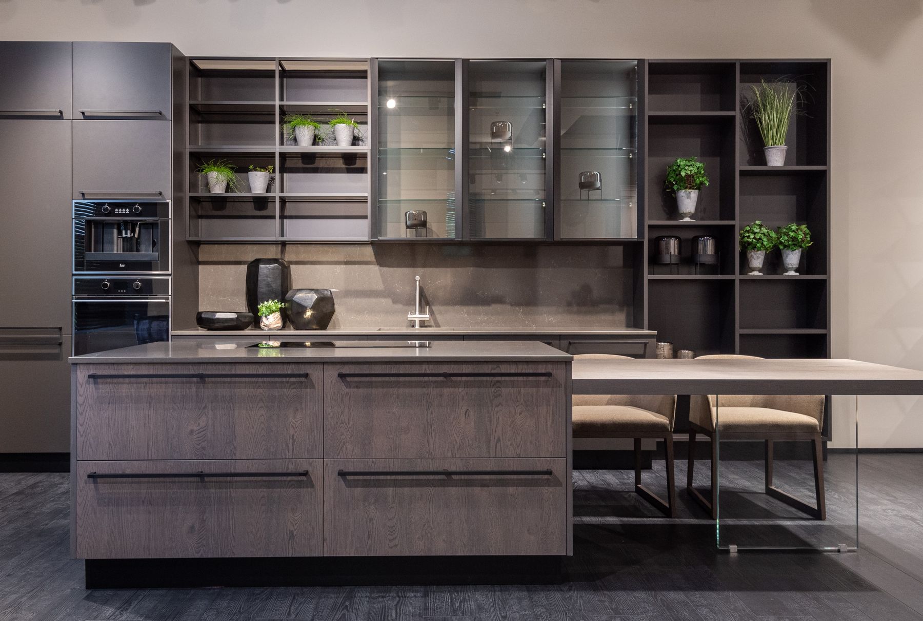 Contemporary kitchen with dark wood fronts, glazed upper cabinets, open shelves and a pale dining extension