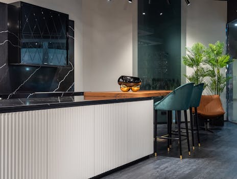 Elegant modern kitchen with sleek bar stools and contemporary decor.