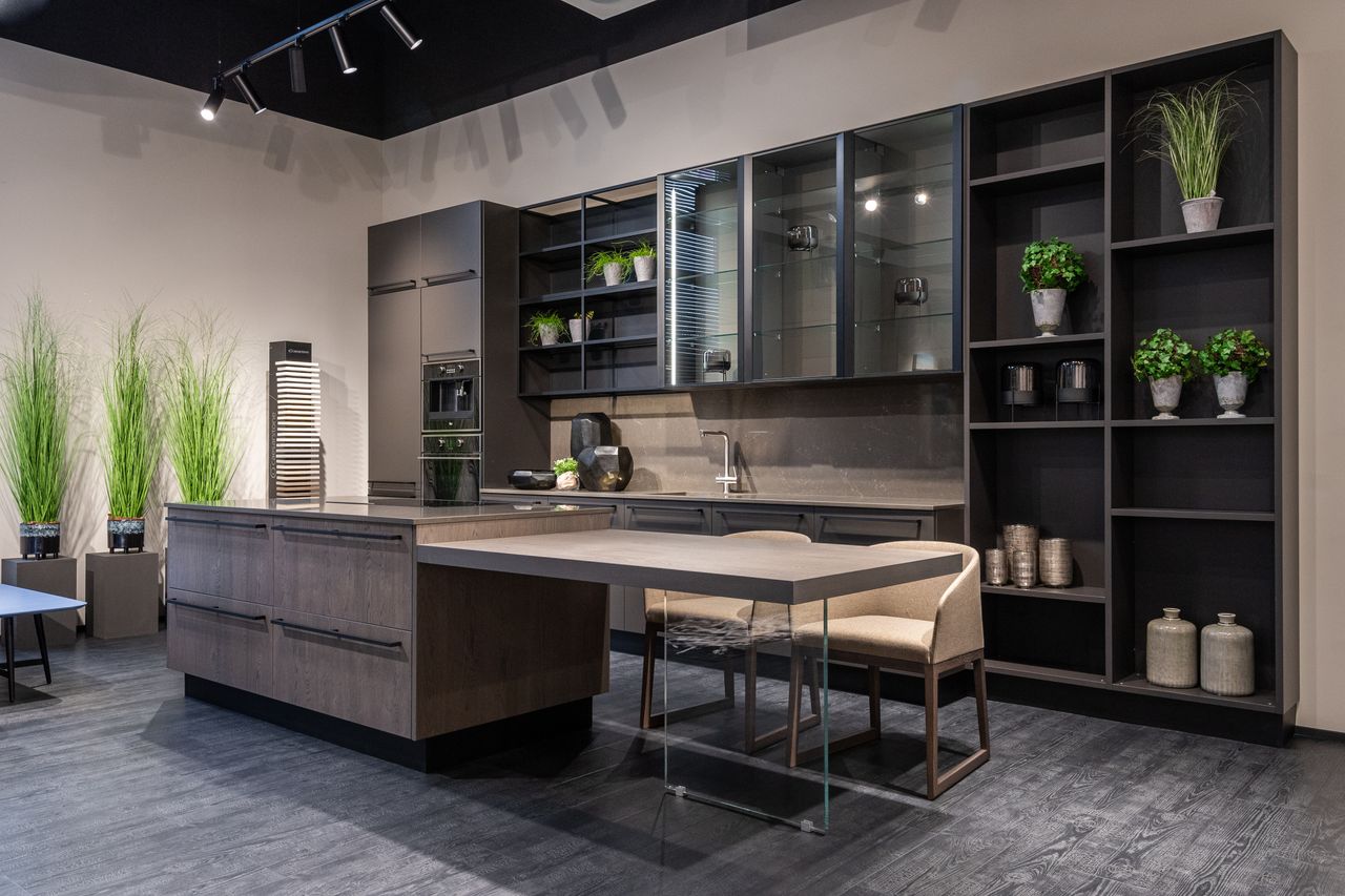 Modern kitchen showroom with black track lighting on the ceiling