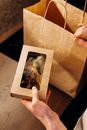 Person Holding White and Brown Box