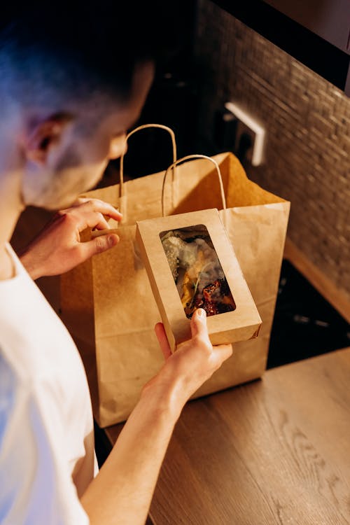 Man Holding Small Box with Food