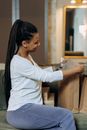 Woman in White Long Sleeve Shirt Sitting on Chair