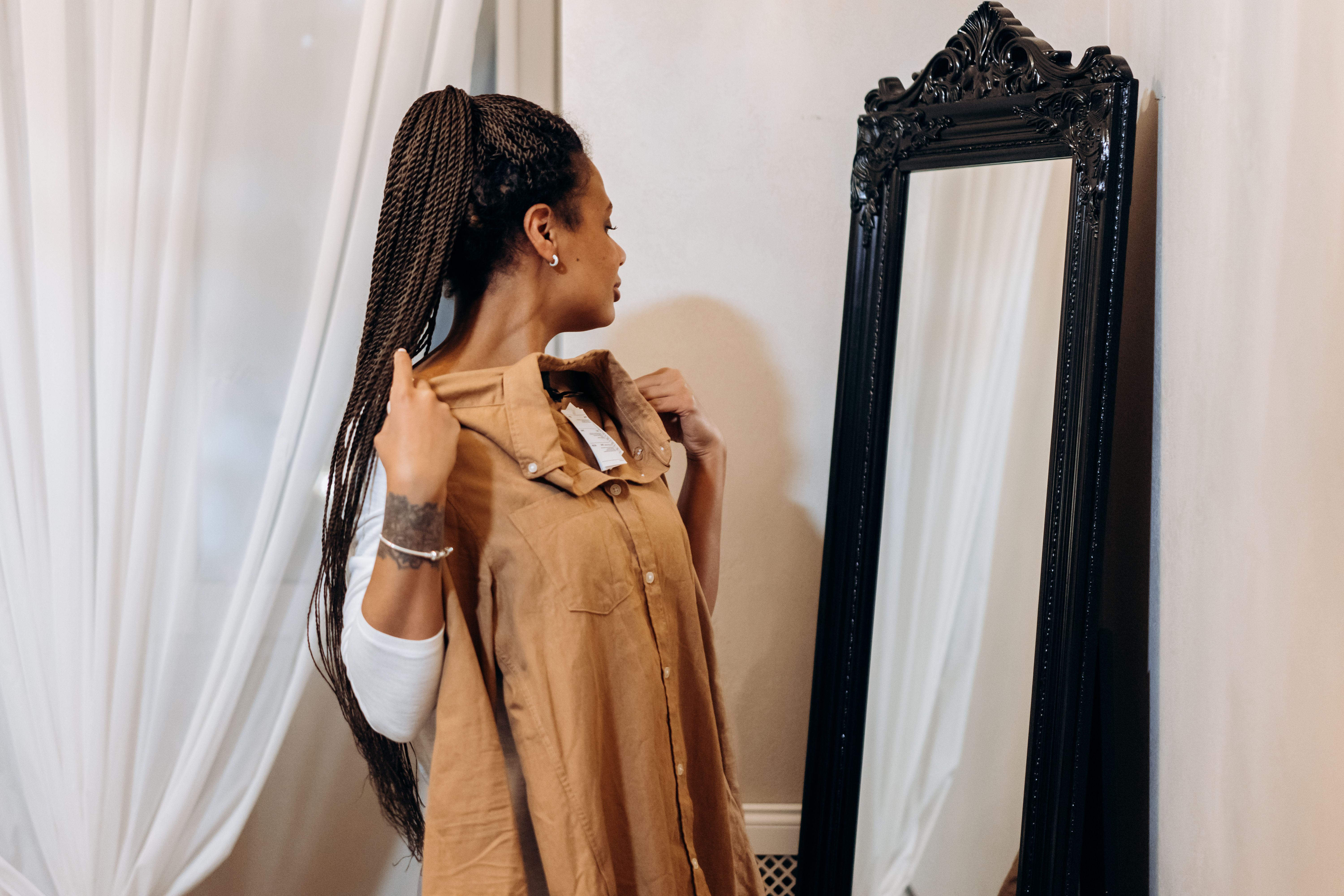 woman braided hair conflicted mirror